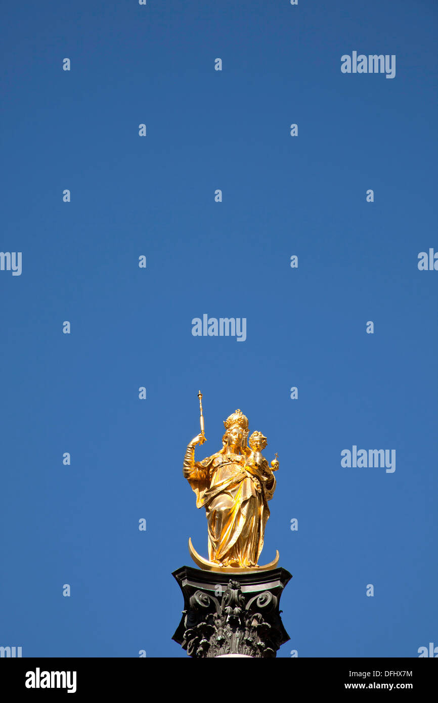 virgin Mary atop the Mariensäule and the church towers of the Frauenkirche in Munich, Bavaria, Germany Stock Photo