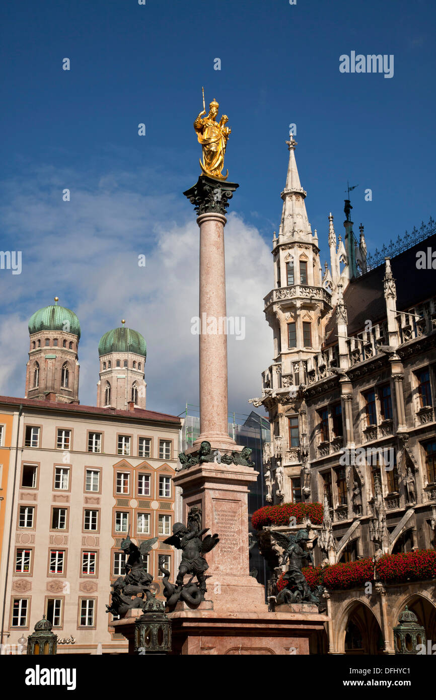 Virgin Mary atop the Mariensaeule, neues Rathaus and the church towers of the Frauenkirche in Munich, Bavaria, Germany Stock Photo