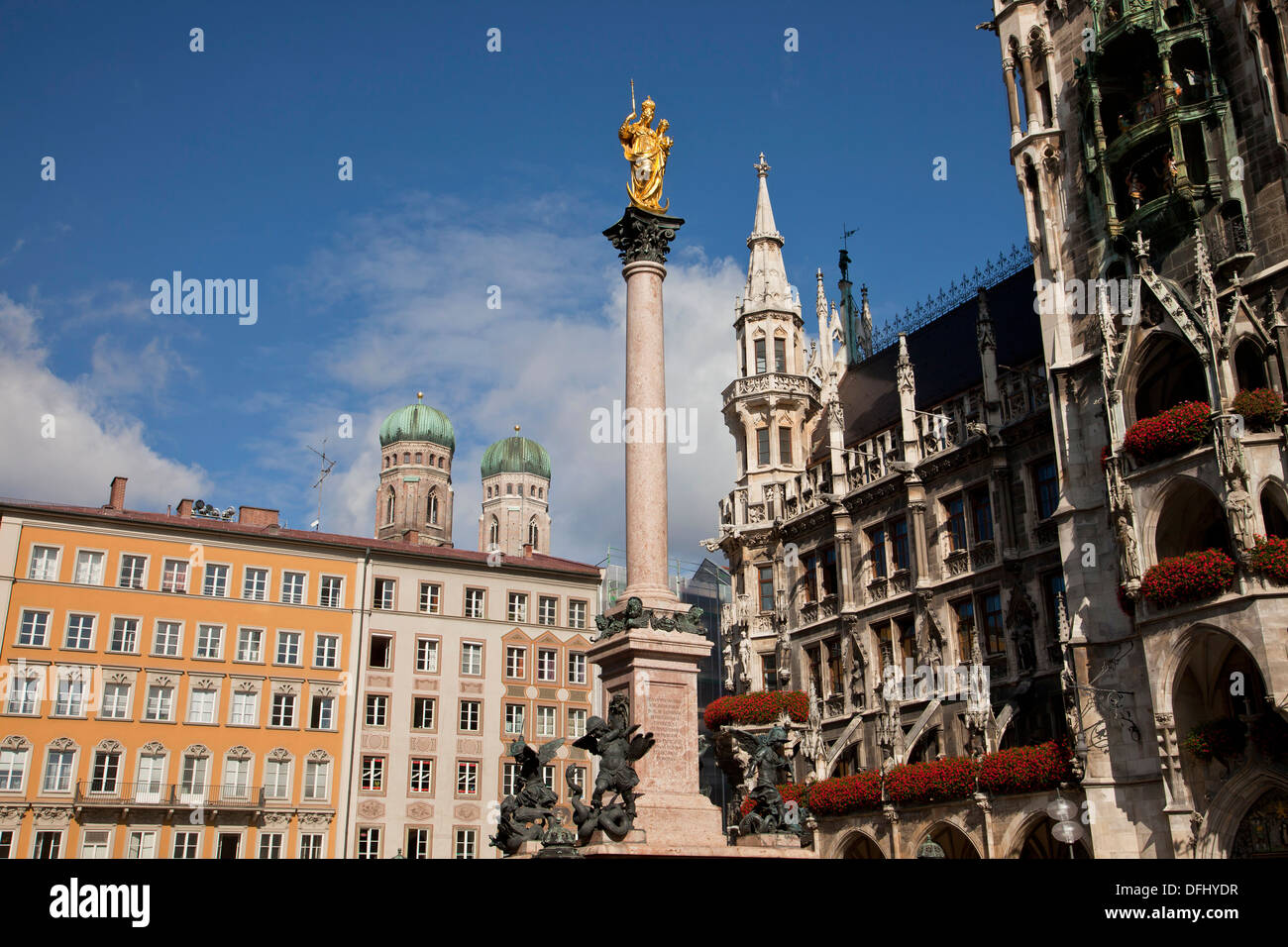 Virgin Mary atop the Mariensaeule, neues Rathaus and the church towers of the Frauenkirche in Munich, Bavaria, Germany Stock Photo