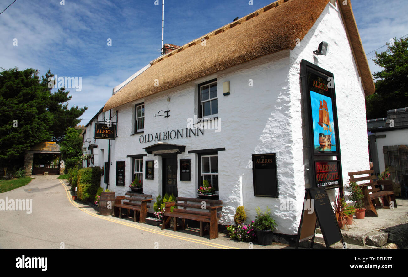 A thatched pub with white walls. Stock Photo