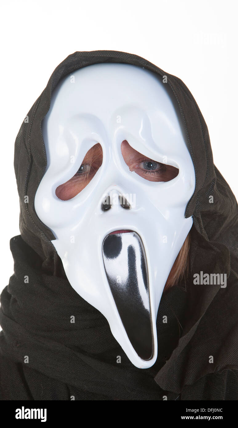 Woman wearing ghost mask at Halloween Stock Photo