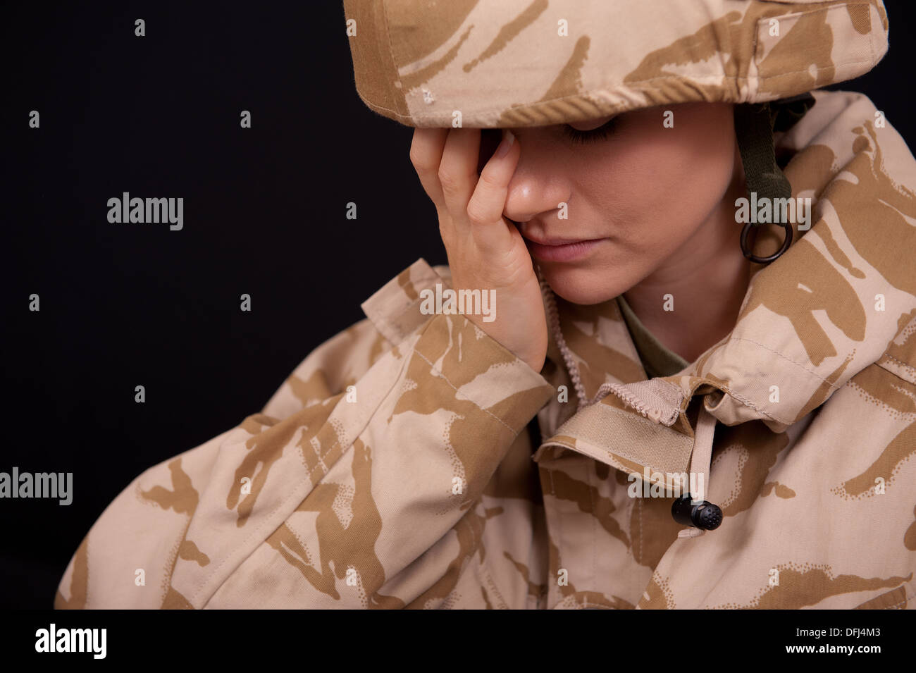 Distraught young female soldier wearing British Military uniform ...
