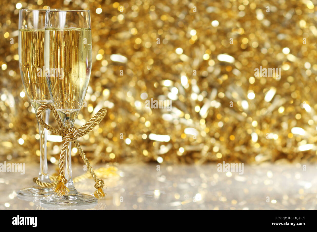 Champagne flutes with golden background Stock Photo - Alamy