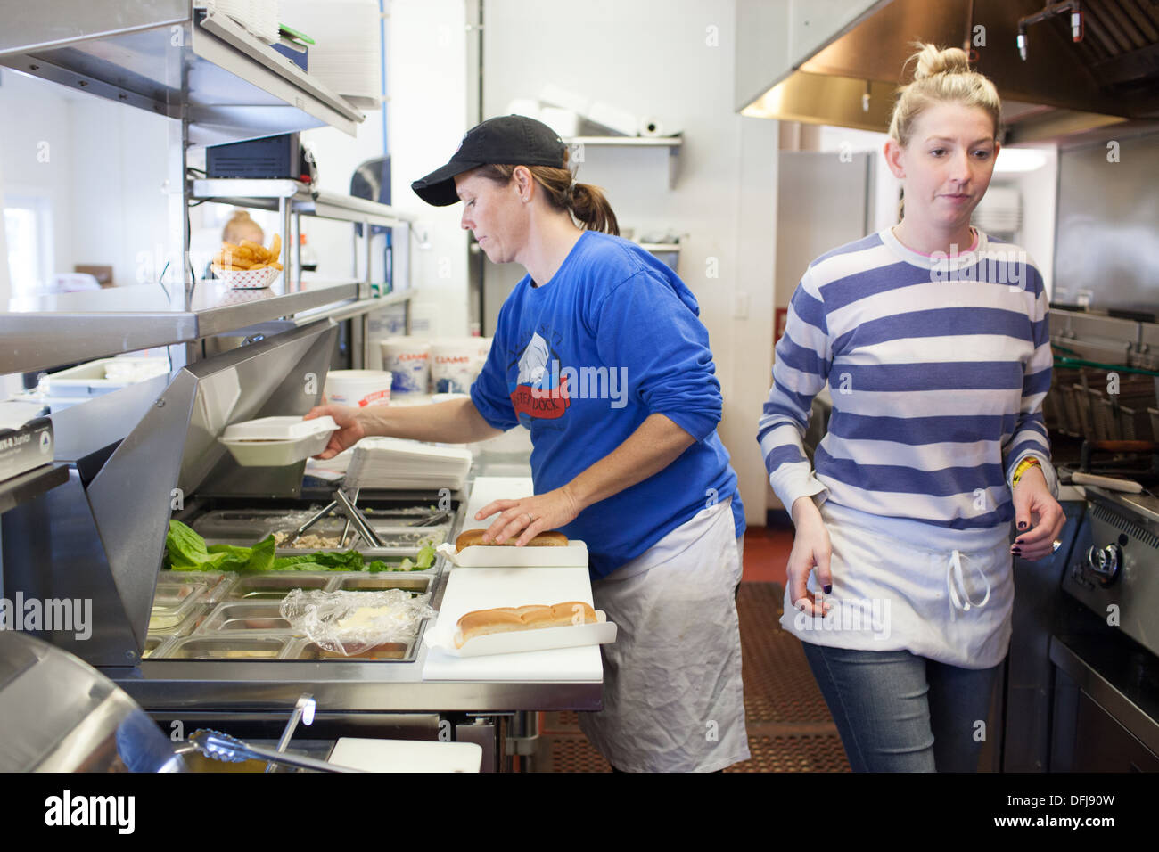 Preparing a lobster roll inside the kitchen at Captain Scott's Lobster