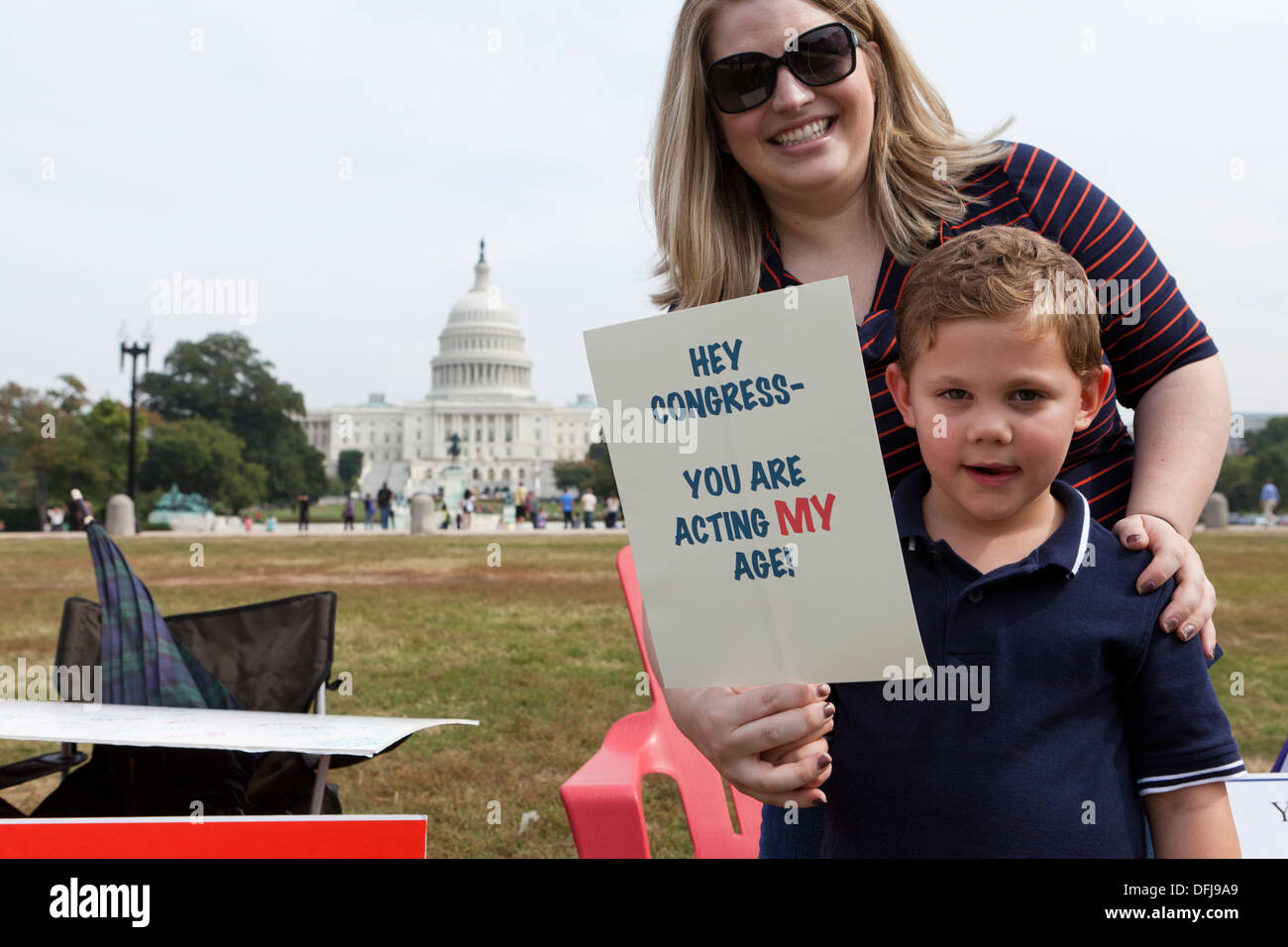Mother and boy protest against government shutdown in front of the US Capitol building Stock Photo