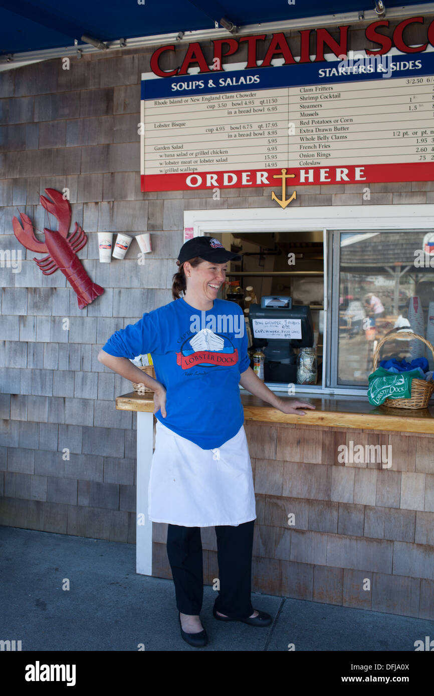 A happy employee at the outdoor order window at Captain Scott's Lobster