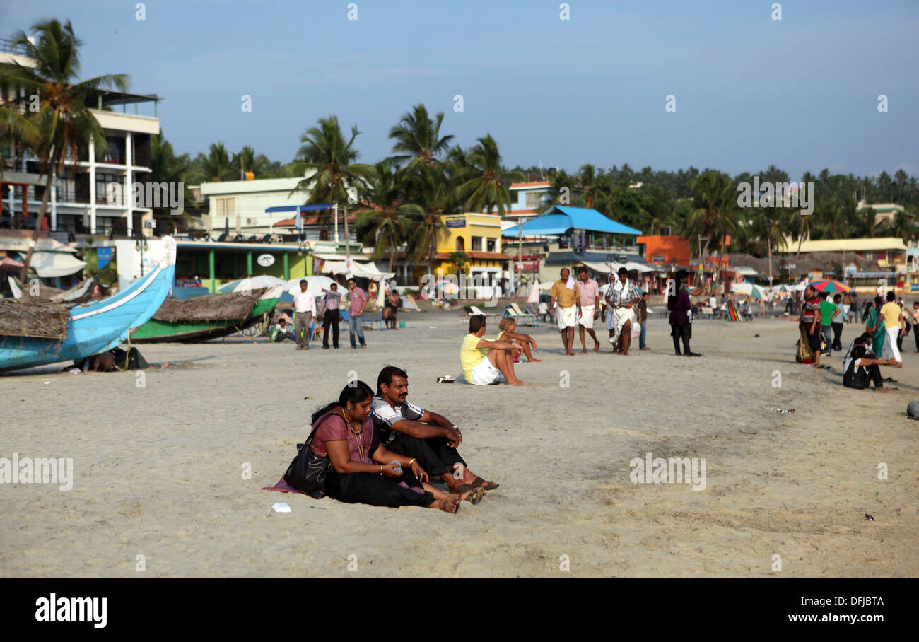 Indian couple sitting on the beach in Kovalam,Kerala,India Stock Photo