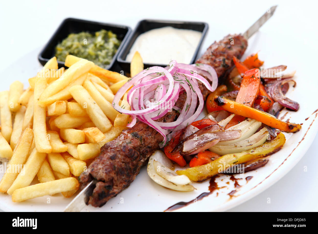 Lamb Kebab skewer on a plate with french fries Stock Photo Alamy