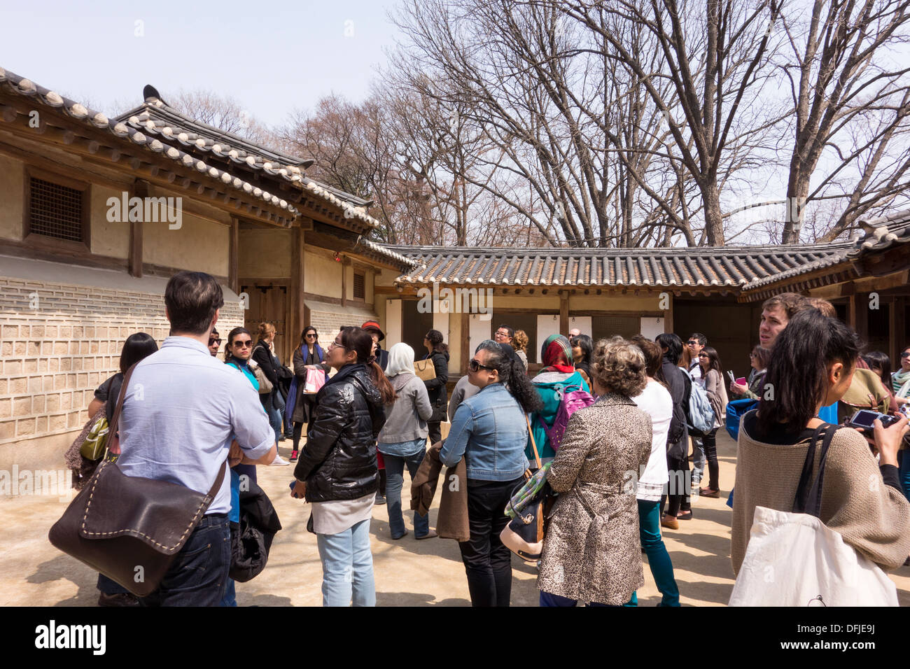 Tourists listening to Official Guide in Changdeokgung Palace, Seoul, Korea Stock Photo