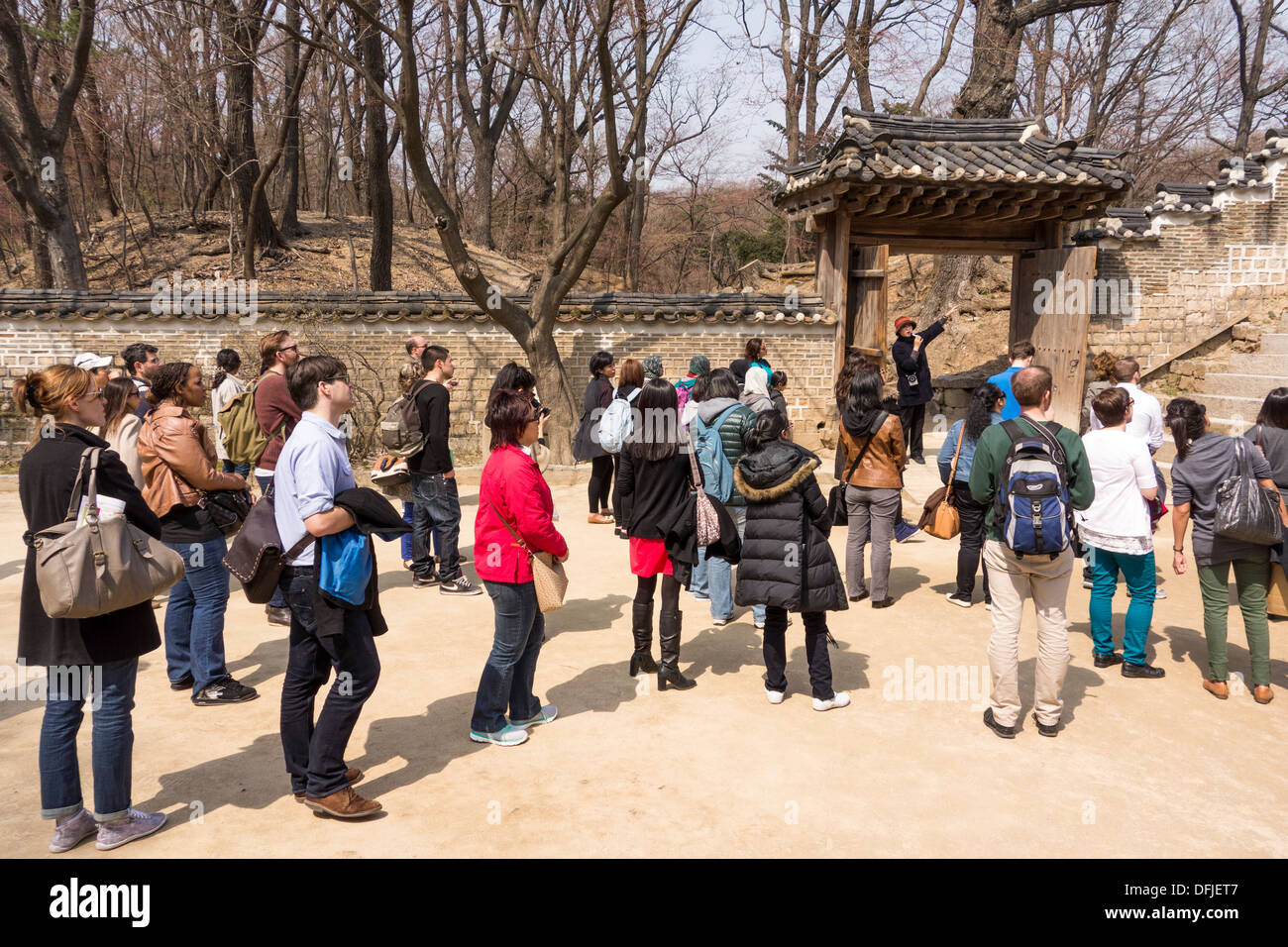 Tourists listening to Official Guide in Changdeokgung Palace, Seoul, Korea Stock Photo