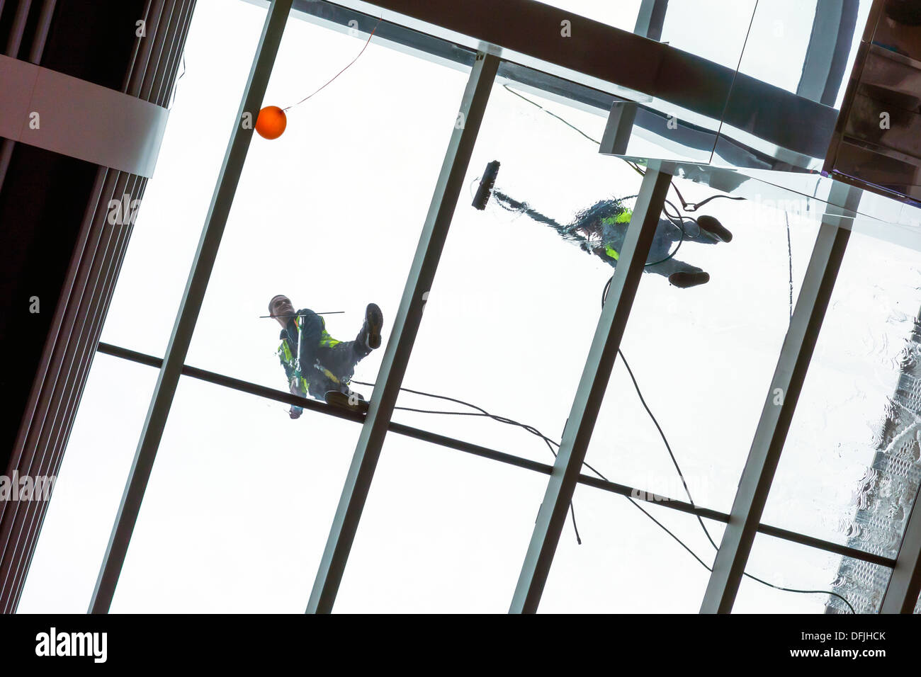 Window cleaning Window Cleaner at work on glass roof. Pure water window cleaning Technology. Stock Photo