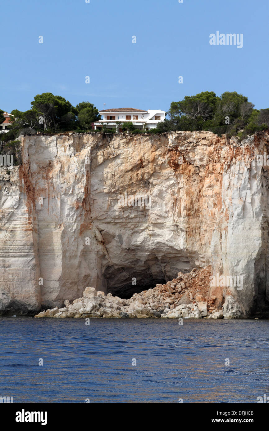 house on the top of eroding cliff Stock Photo