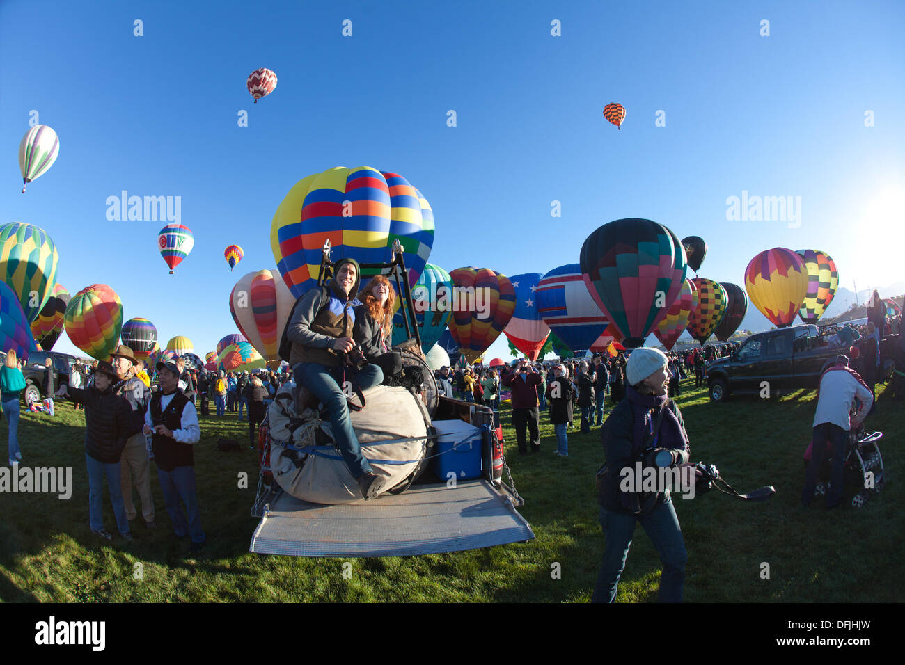 Albuquerque, NM, USA. 5th Oct, 2013. . A man and woman sit on packed balloon equipment in a truck while watching balloons ascend, First day of mass ascension at Albuquerque International Balloon Fiesta on Saturday October 5, 2013. Albuquerque, New Mexico, USA. Credit:  Christina Kennedy/Alamy Live News Stock Photo