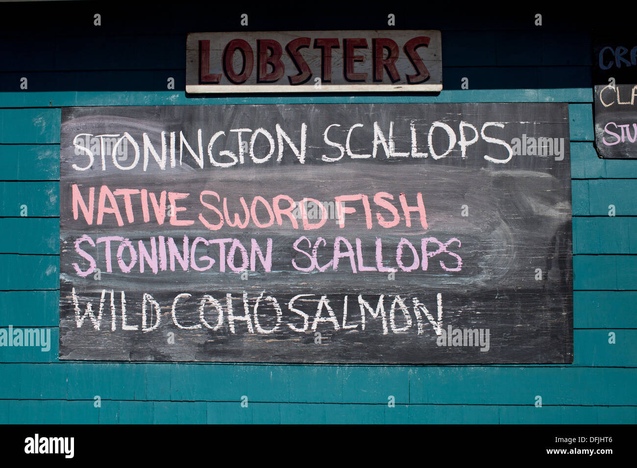 Chalkboard menus outside of the Sea Well Seafood fresh fish market in