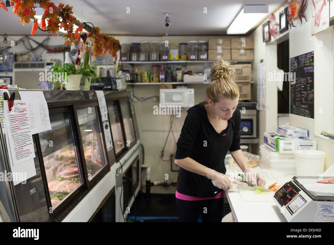 Shelby Smith weighing the lobster and preparing a lobster roll in a Pawcatuck, Connecticut