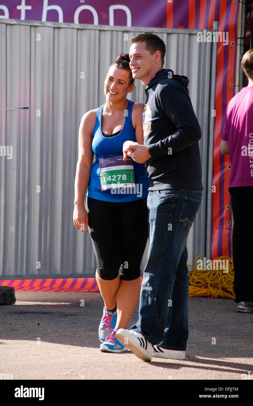 Bournemouth, UK 6 October 2013. Double celebration as Scott Hudson proposes  to his girlfriend Kimberley Bracher and presents her with a diamond ring as  she crosses the line of her first half-marathon