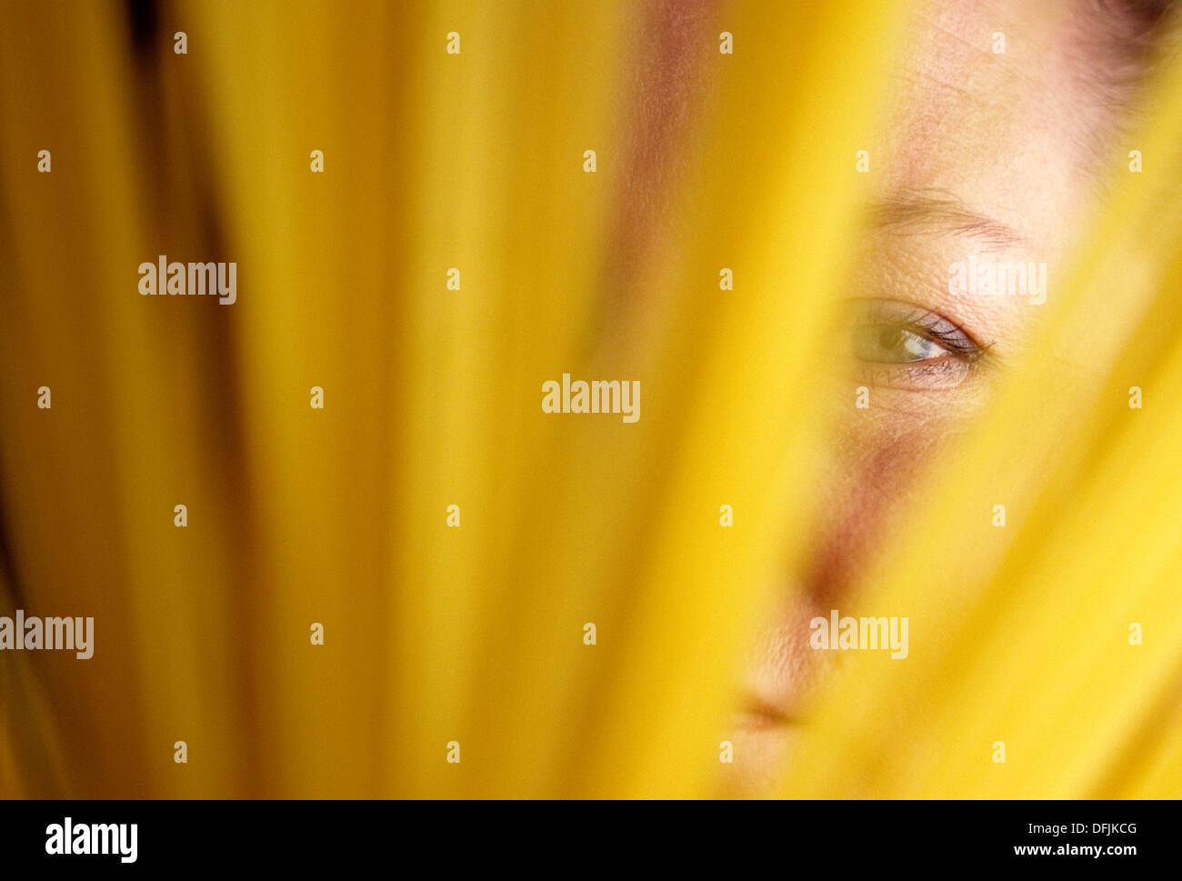 Woman's holding spaghetti with eye looking through spaghetti Stock Photo