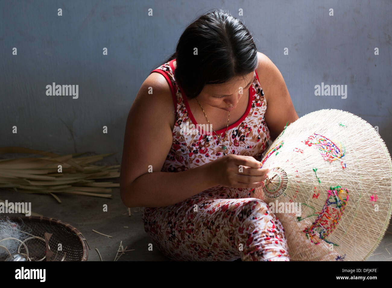 Group of Vietnamese woman working as handicraftsman to make conical straw hat at trade village, Vietnam Stock Photo