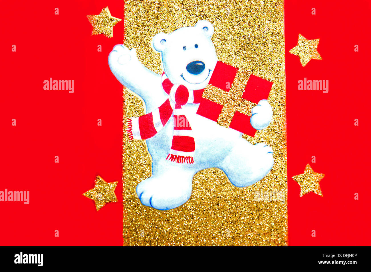 Fun novelty bear dancing with a Christmas present in the festive season on a  Christmas card Stock Photo