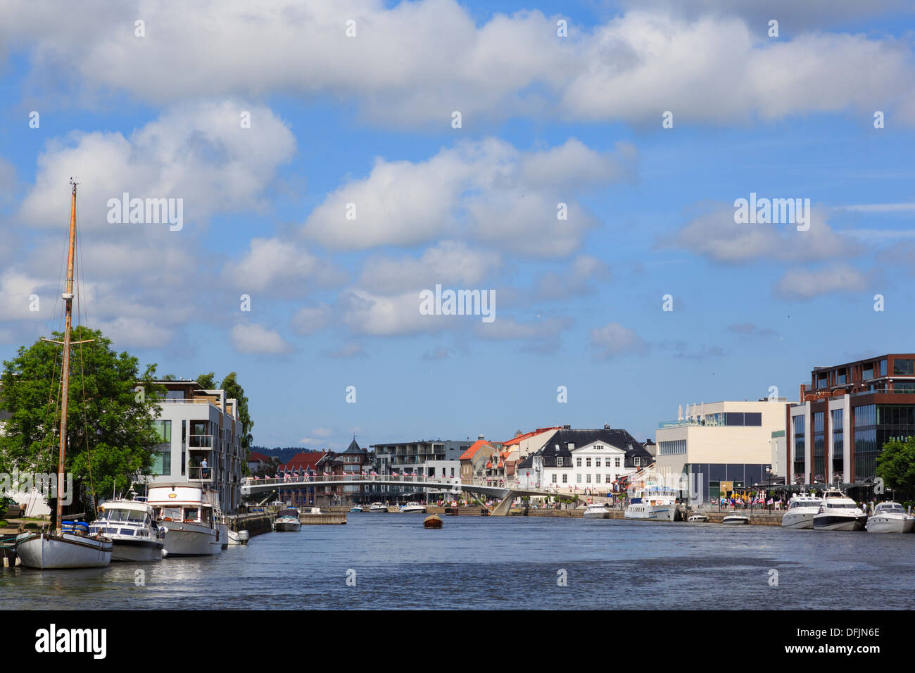 View to footbridge across River Glomma with boats moored in new town district of Fredrikstad, Ostfold, Norway, Scandinavia Stock Photo