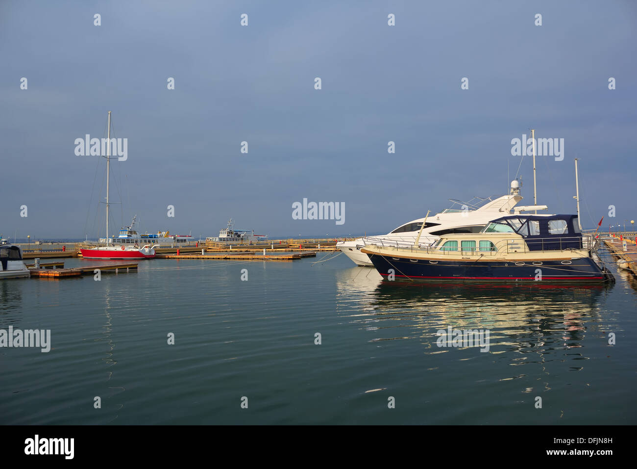 Red and white yacht anchored in the harbor Stock Photo - Alamy