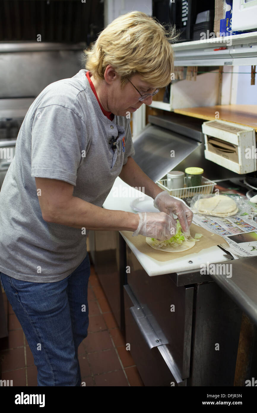 Amanda Maybeck cooks fish taco at Champlin's Seafood restaurant Stock Photo