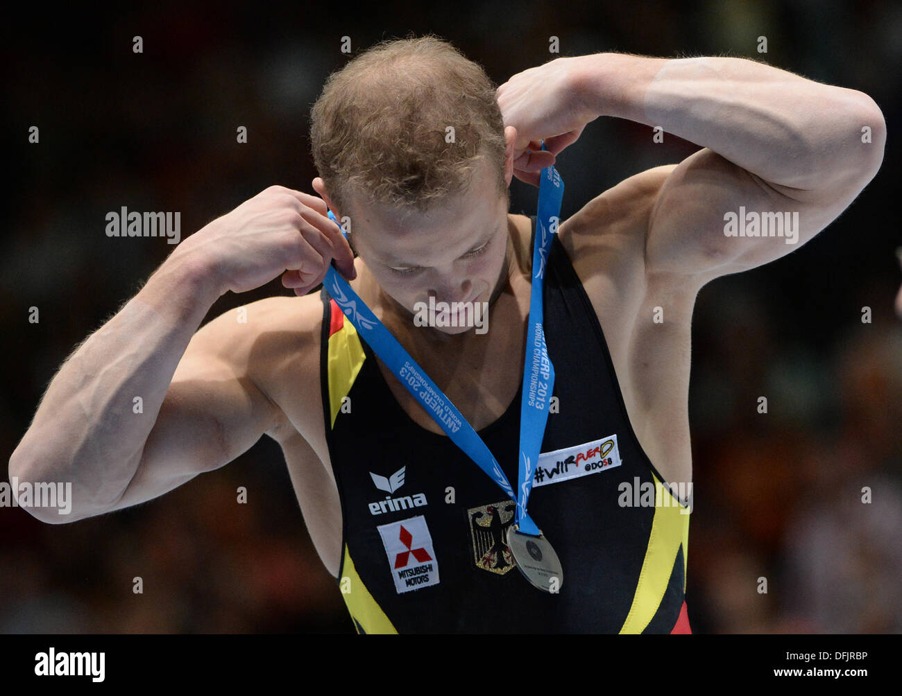 Antwerp, Belgium. 06th Oct, 2013. Germany's Fabian Hambuechen poses with his silver medal for his performance on the horizontal bar during the Artistic Gymnastics World Championships in Antwerp, Belgium, 06 October 2013. Photo: MARIJAN MURAT (For editorial use only)/dpa/Alamy Live News Stock Photo
