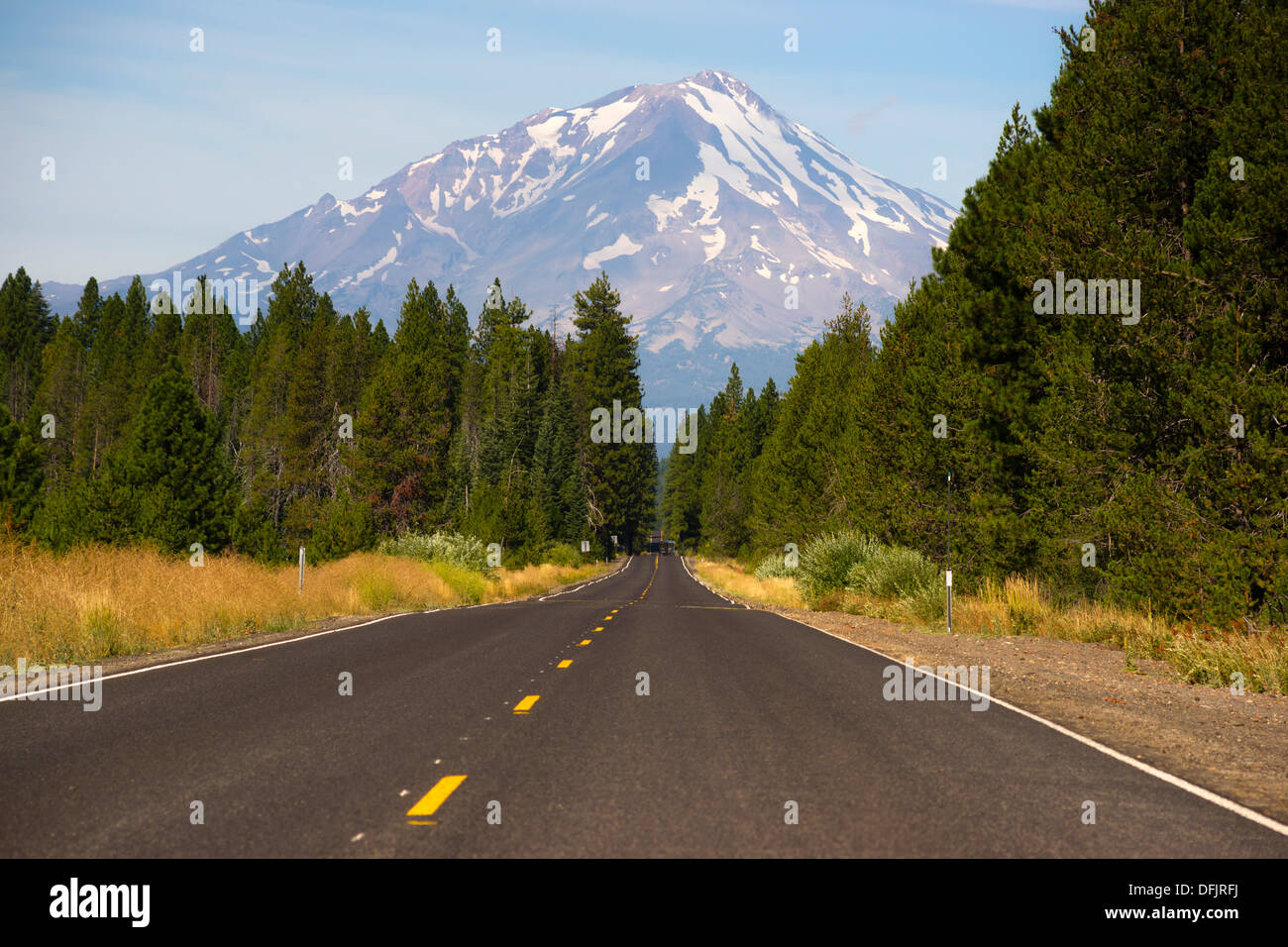 Two lane road heads west across California Mountain Landscape Stock Photo