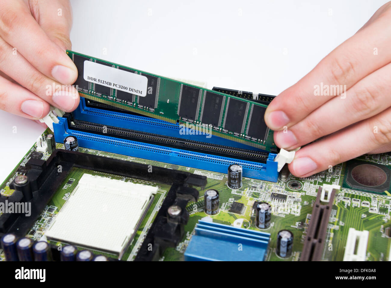 Man installing memory. PC motherboard RAM upgrade Stock Photo