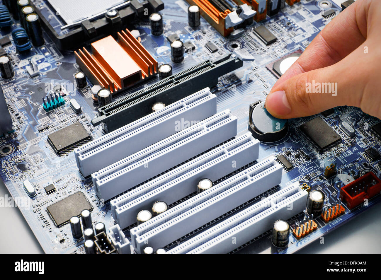 Hand install battery to PC motherboard Stock Photo Alamy