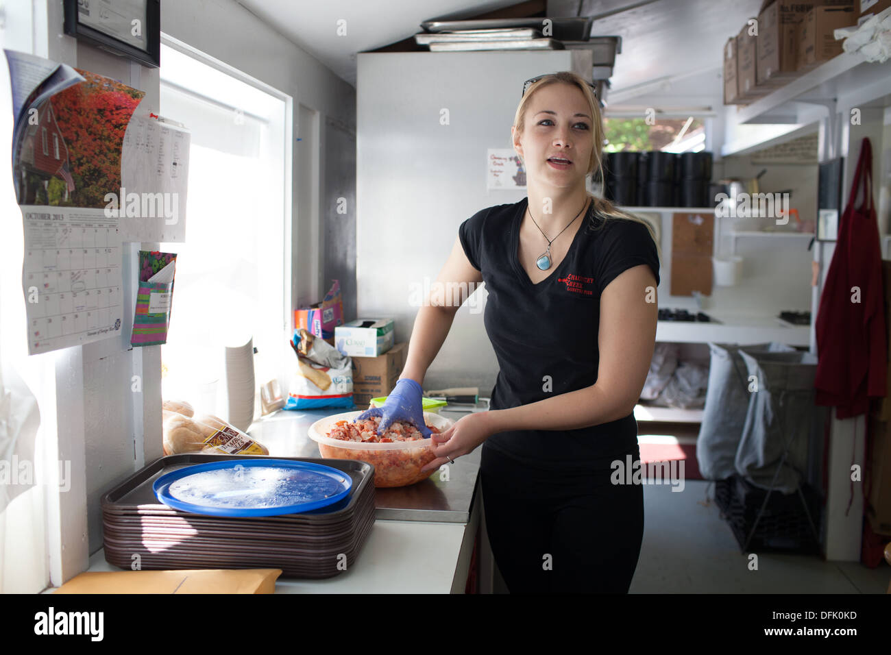 Kelly Skanes prepares a lobster roll at Chauncey Creek Lobster Pier. Stock Photo