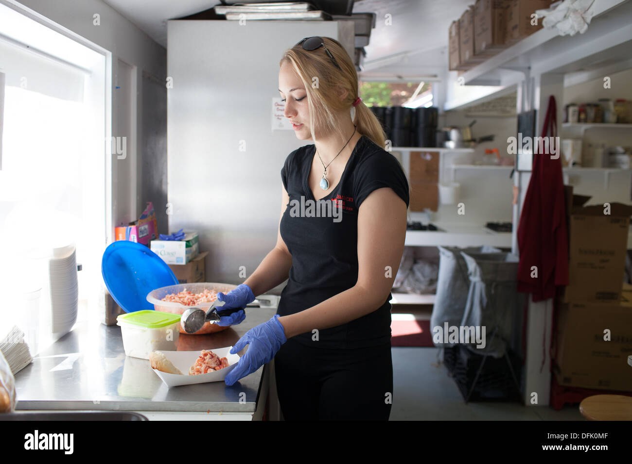 Kelly Skanes prepares a lobster roll at Chauncey Creek Lobster Pier