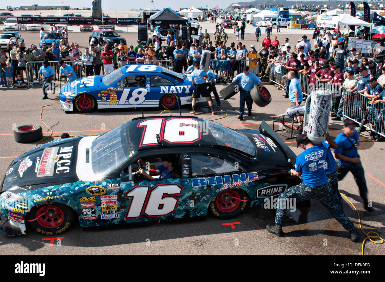 US Navy Sailors compete during the Military Pit Crew Challenge at the 16th Annual NASCAR Coronado Speed Festival September 21, 2013 in San Diego, CA. The event was held as a part of San Diego Fleet Week to help promote partnership between military and local communities. Stock Photo