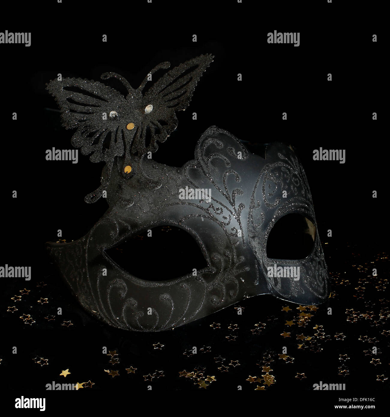 Carnival mask and champagne on black background Stock Photo