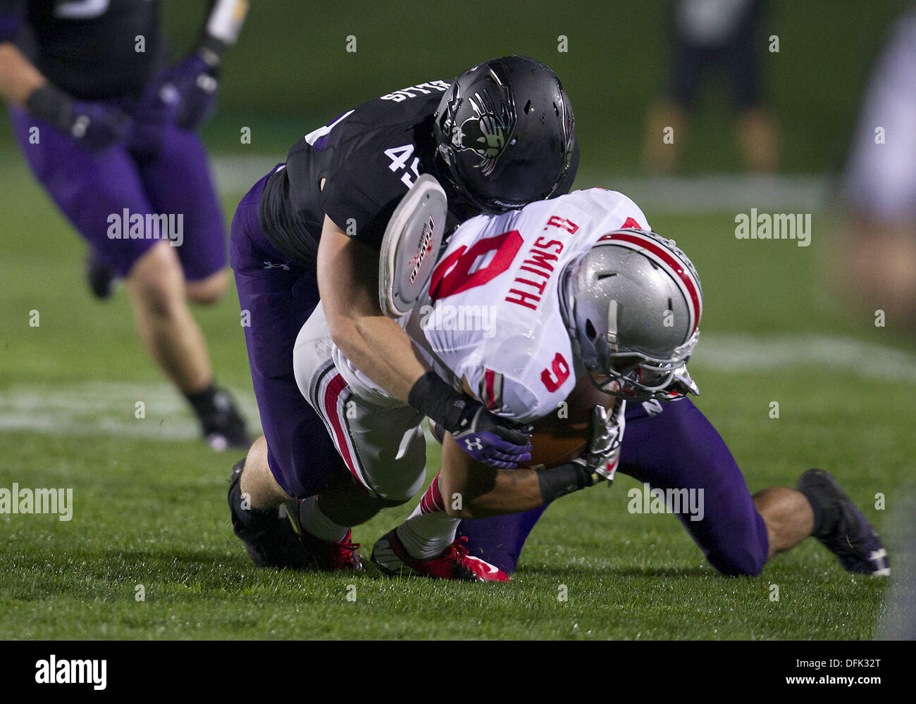 Evanston, Illinois, USA. 5th Oct, 2013. October 05, 2013: Ohio State wide receiver Devin Smith (9) is tackled by Northwestern linebacker Collin Ellis (45) during NCAA Football game action between the Ohio State Buckeyes and the Northwestern Wildcats at Ryan Field in Evanston, Illinois. Ohio State defeated Northwestern 40-30. Credit:  csm/Alamy Live News Stock Photo