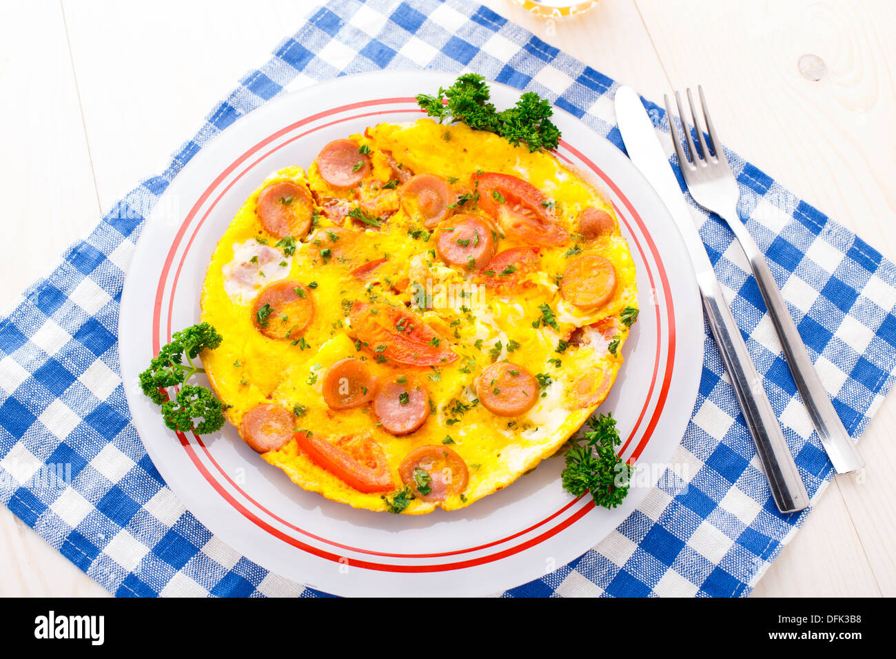 Omelette with slices of sausage and tomato Stock Photo