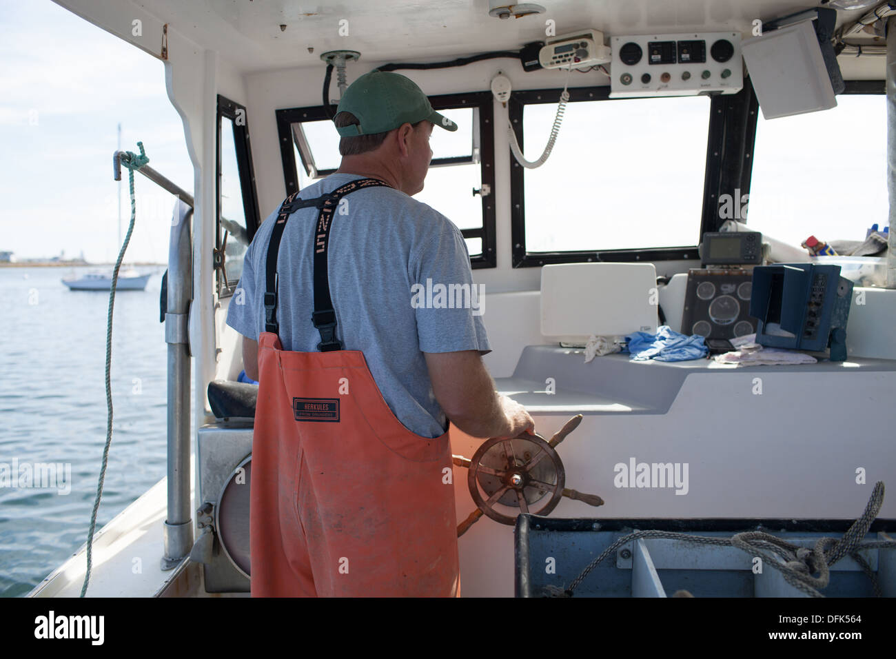 Lobsterman Eric Emmons driving lobster boat. Stock Photo