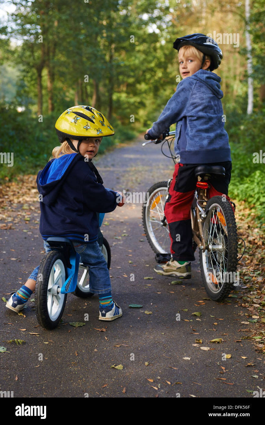 2 children - siblings on a bicycle tour, bike path Stock Photo