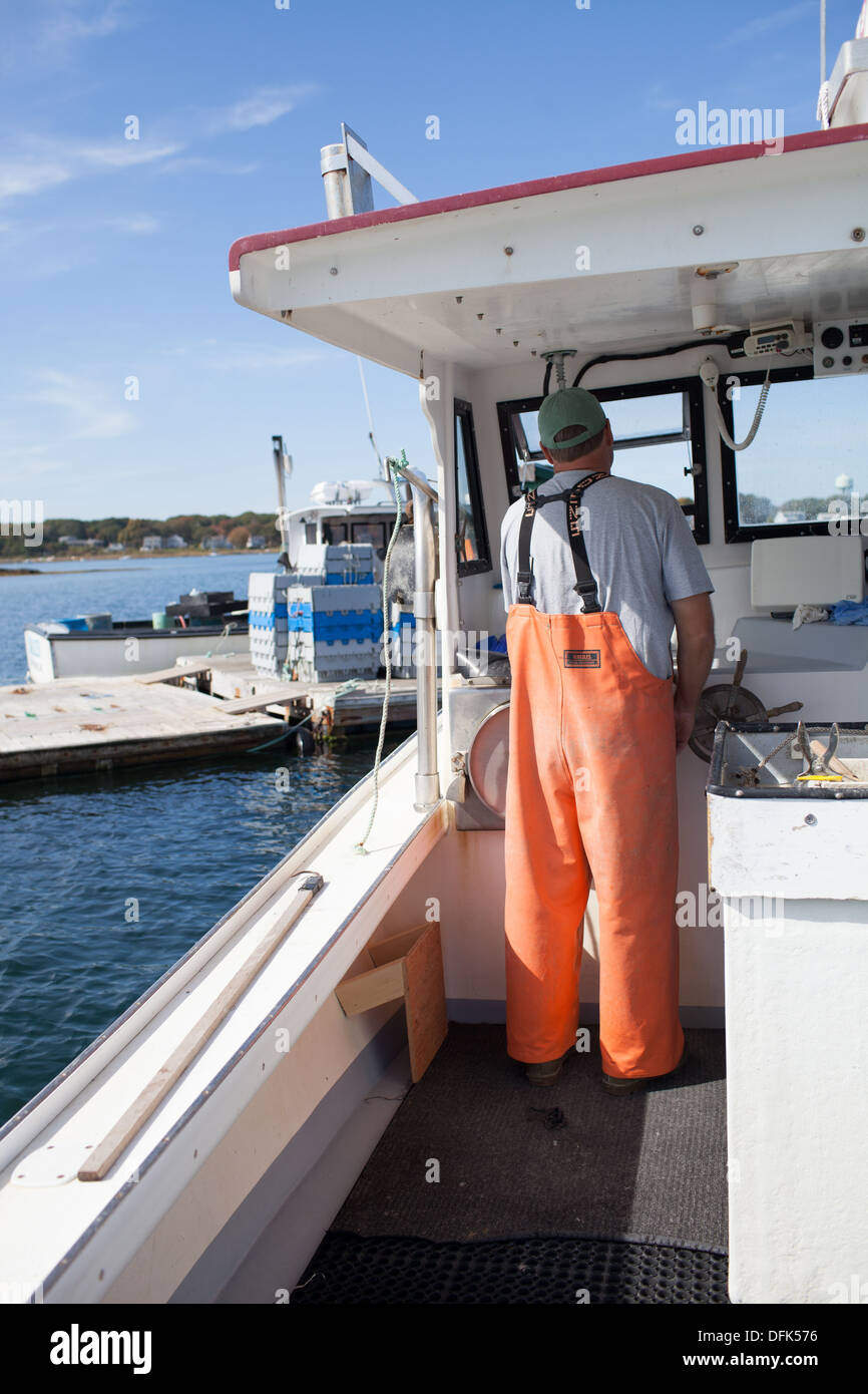 Lobsterman Eric Emmons departs lobster dock after purchasing additional lobsters for his clients. ME Maine New England Stock Photo
