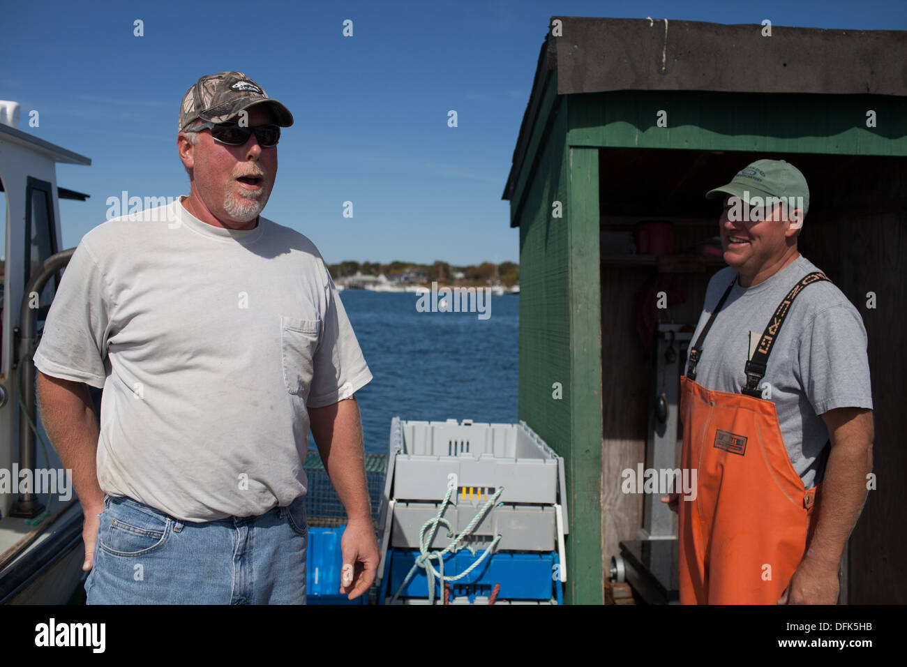 Lobsterman Peter Wildes on lobster dock in Maine getting ready to sell