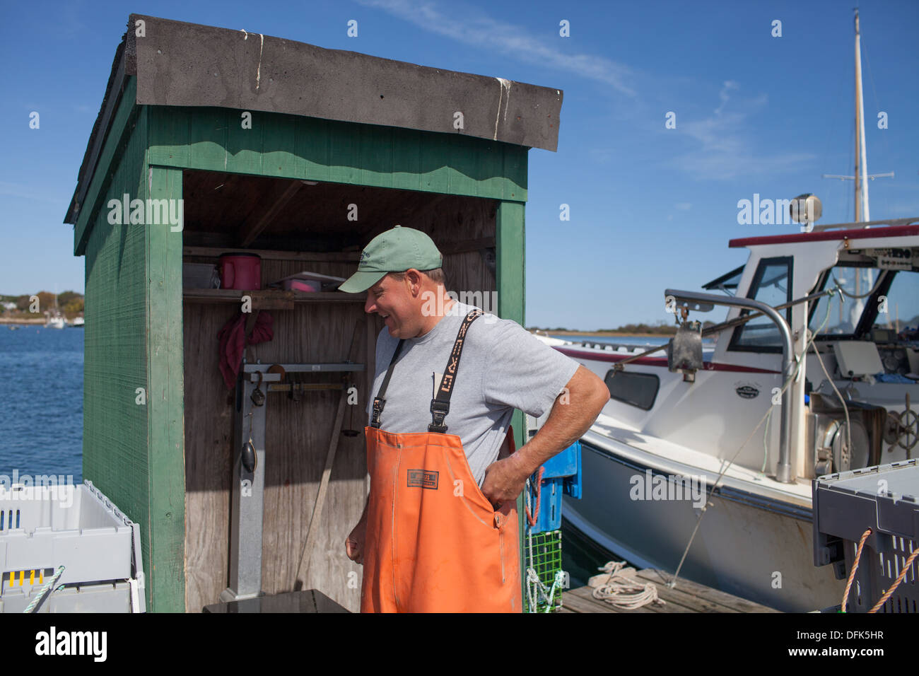 Lobsterman Eric Emmons on lobster dock in Maine getting ready to weigh