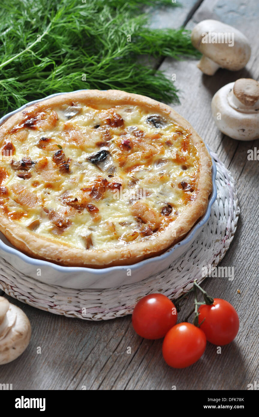 Traditional french quiche pie with chicken and mushroom on a plate