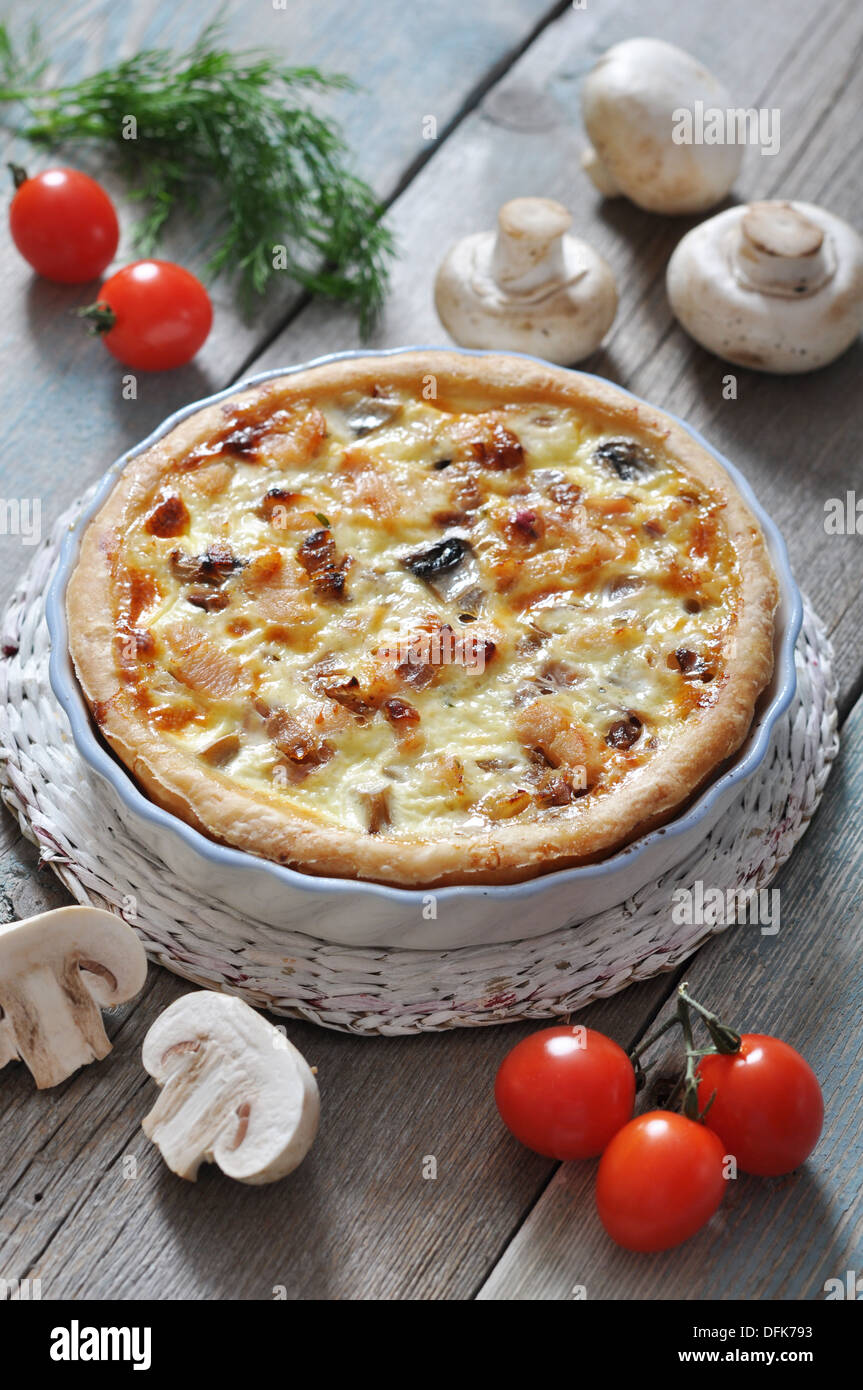 Traditional french quiche pie with chicken and mushroom on a plate
