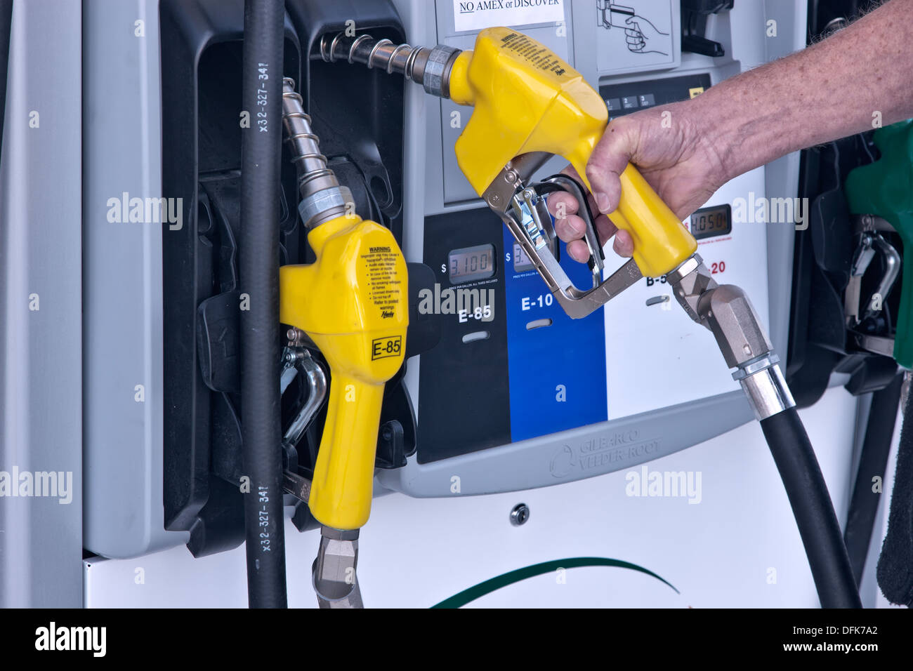Biofuel pump, hand removing nozzle, service station. Stock Photo