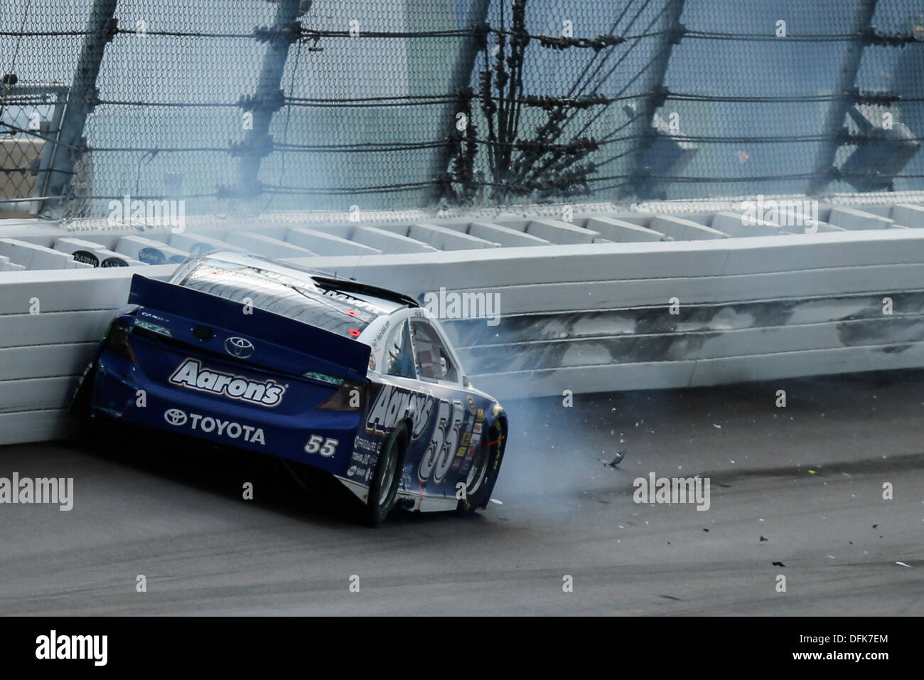 Kansas City, KS, USA. 6th Oct, 2013. October 06, 2013: Mark Martin, driver of the #55 Aaron's Dream Machine Toyota, slams into the wall during the Nascar Sprint Cup Hollywood Casino 400 at Kansas Speedway in Kansas City, KS. Credit:  csm/Alamy Live News Stock Photo