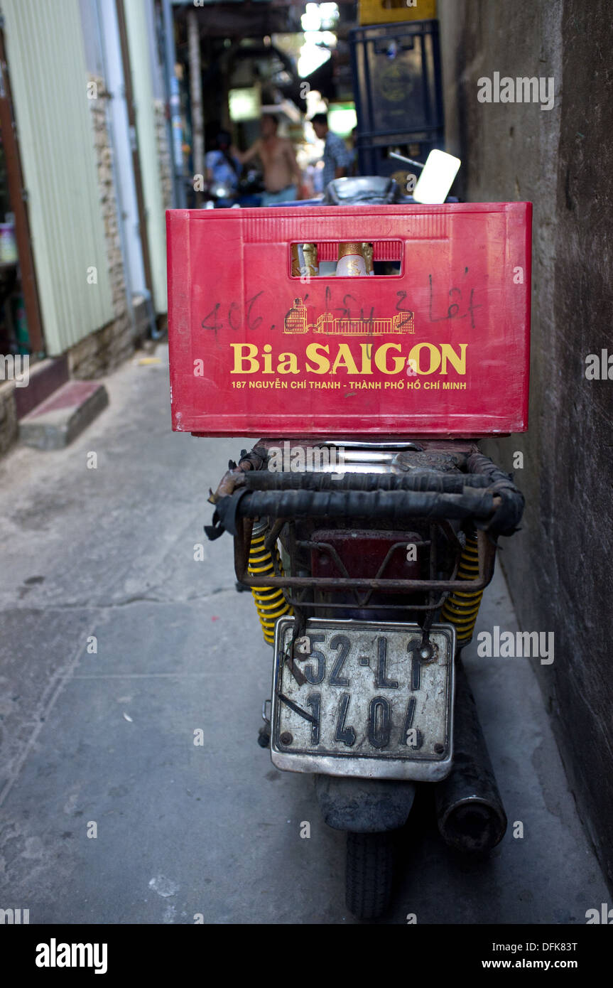 'Bia Saigon' (Saigon beer) crate on the back of a motorbike parked in an alley in Saigon, Vietnam Stock Photo