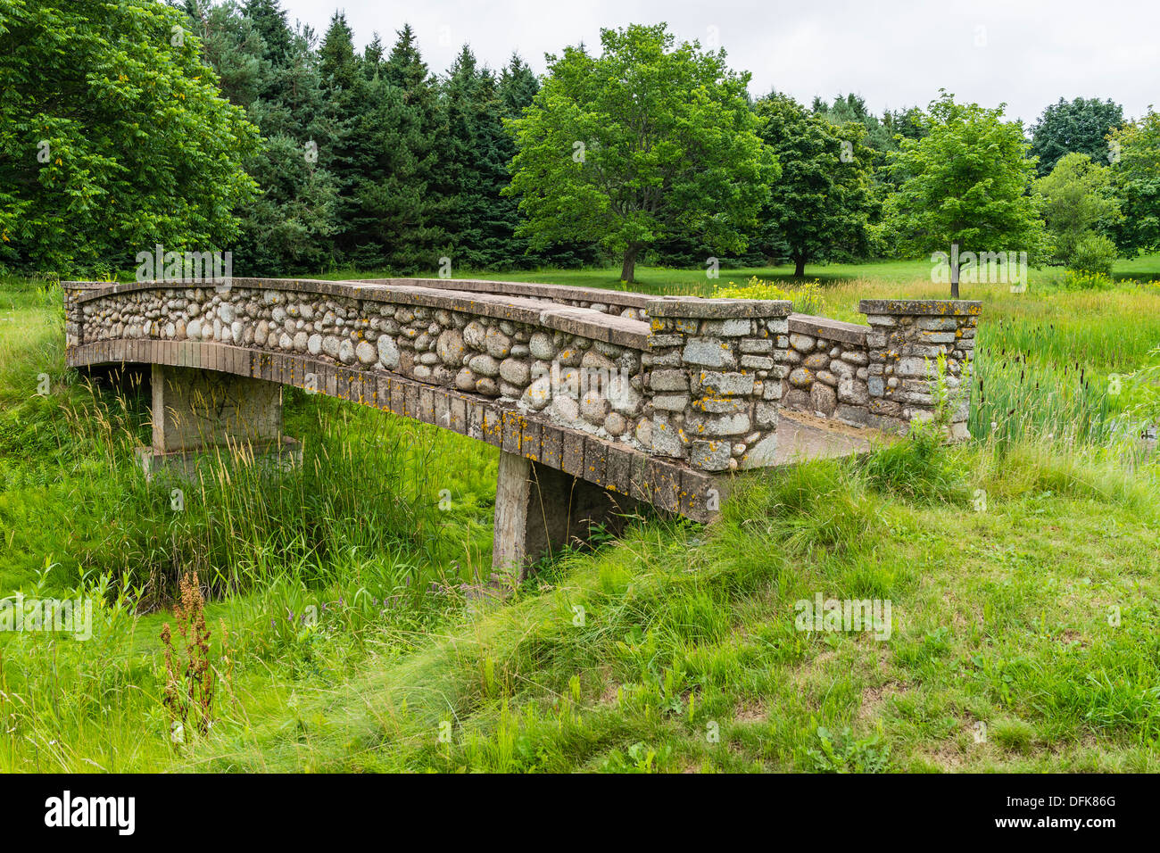 Stone bridge in a meadow at Woodleigh Replicas a deserted tourist