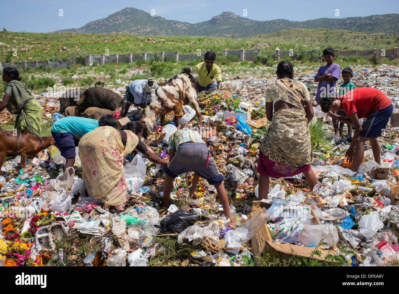 Poor Indian women and children collecting pickings from a rubbish tip. Andhra Pradesh, India Stock Photo
