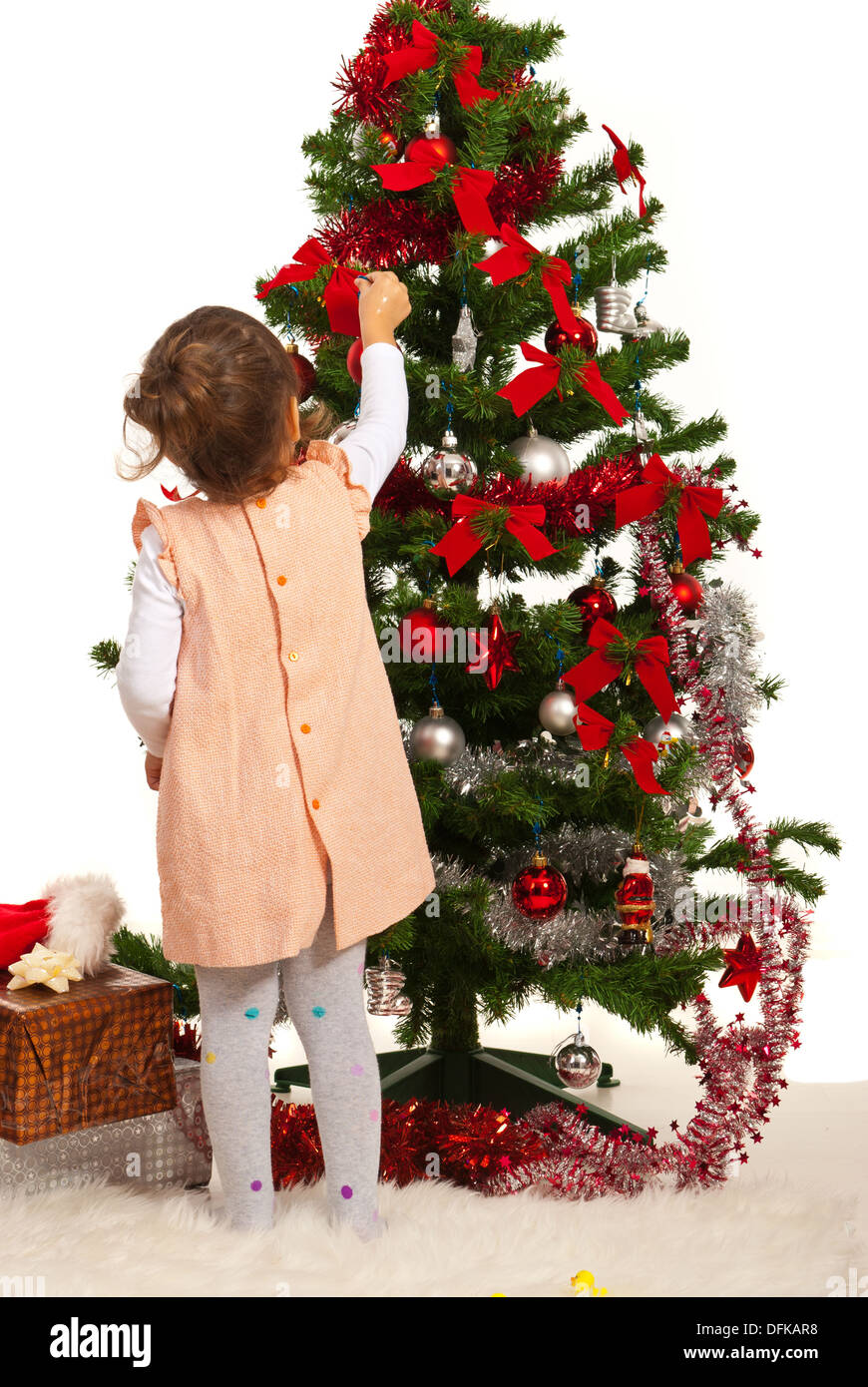 Back of little girl decorate Christmas tree Stock Photo - Alamy