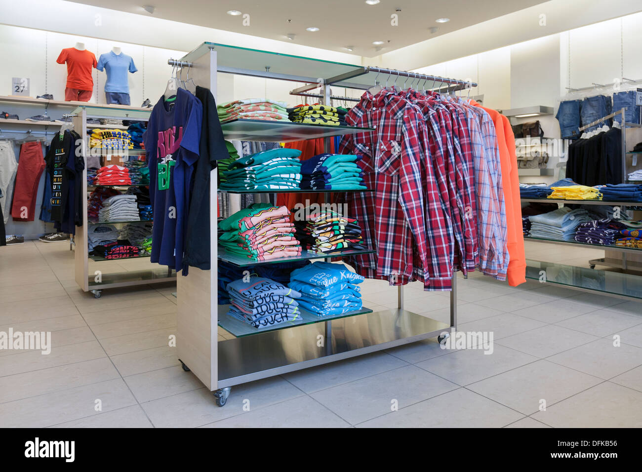 Clothes and shirts, blouses on rack. Retail shop interior Stock Photo